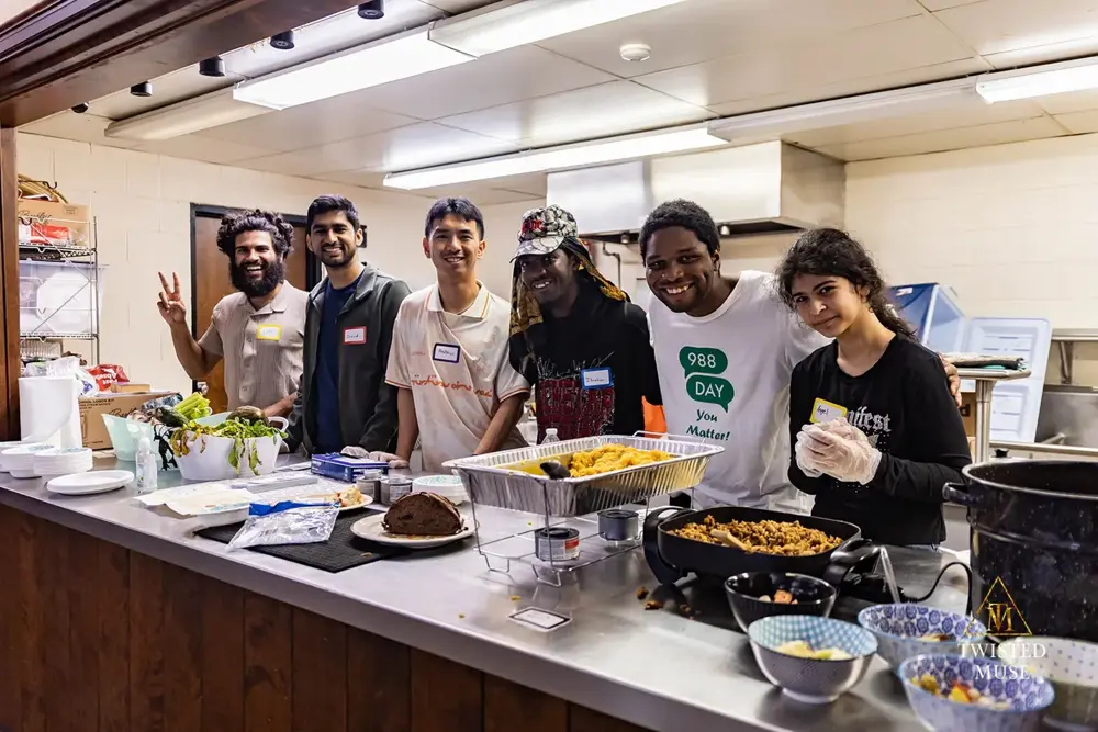 The Foodways group gathered with smiles around the dishes they prepared for the Neighborhood House community health fair