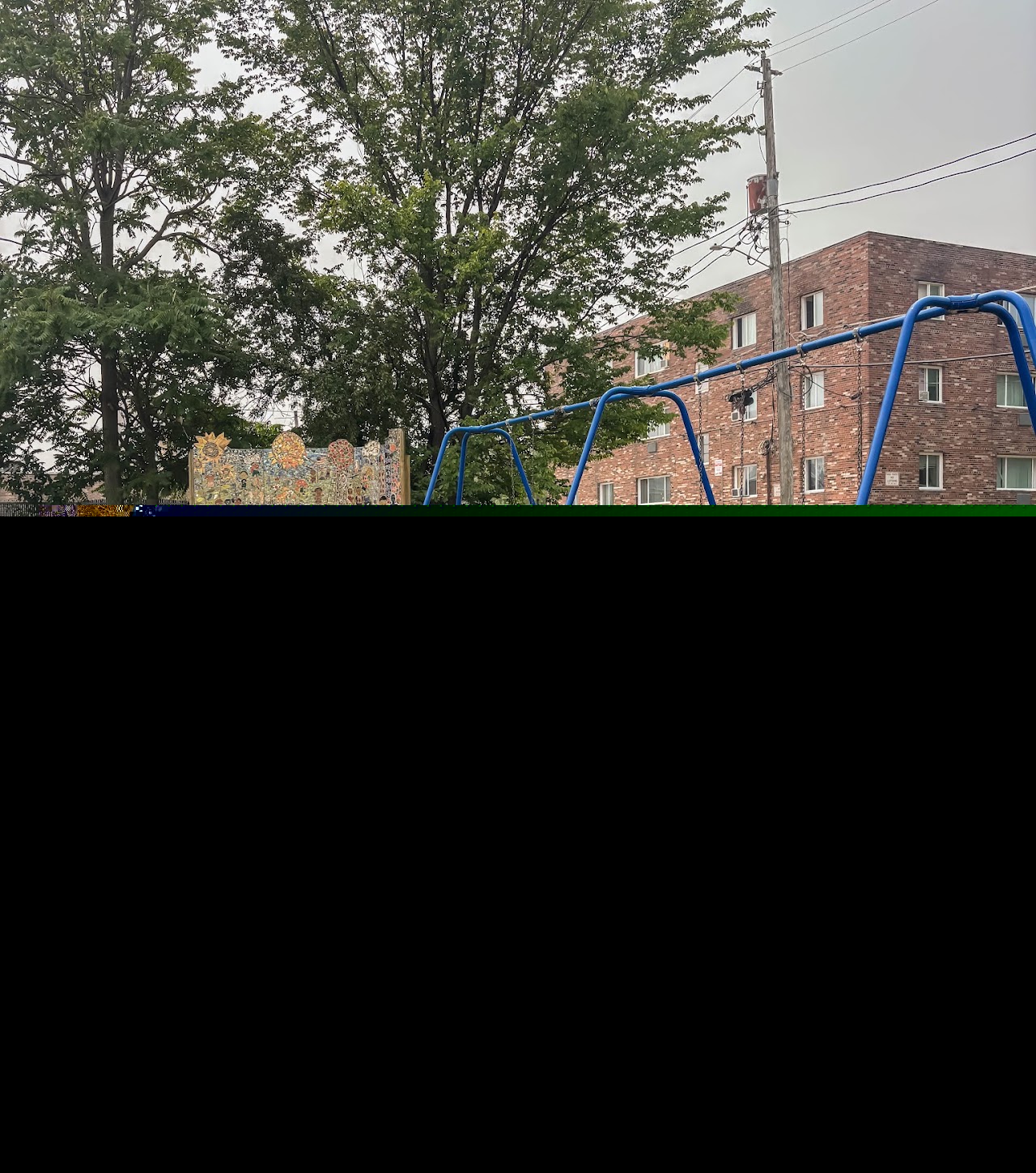 Garden Park swings, mural, and overgrown site during the early launch period